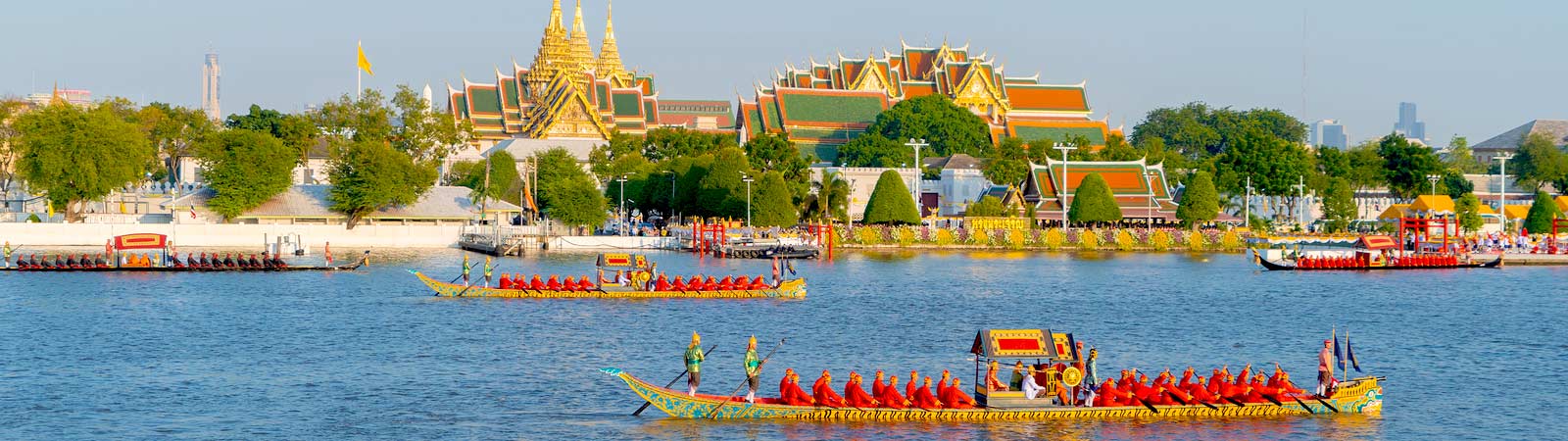 Bangkok's Grand Palace and Temple of Emerald Buddha (Wat Phra Kaew) with the royal barge procession for The Thai King on Chao Phraya River on a Thailand tour